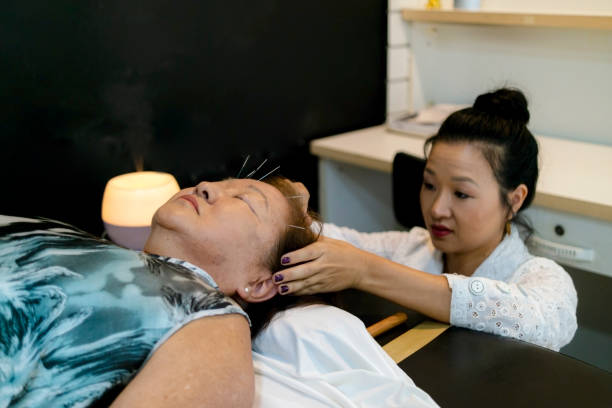 Japanese acupuncturist and a patient.